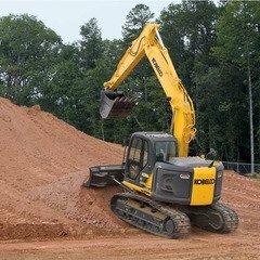 Excavator pushing dirt pile